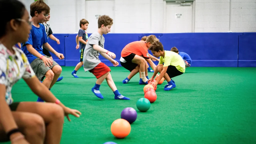 Strong Camp playing dodge ball at turf at Strong Fitness & Performance in Farmers Branch.