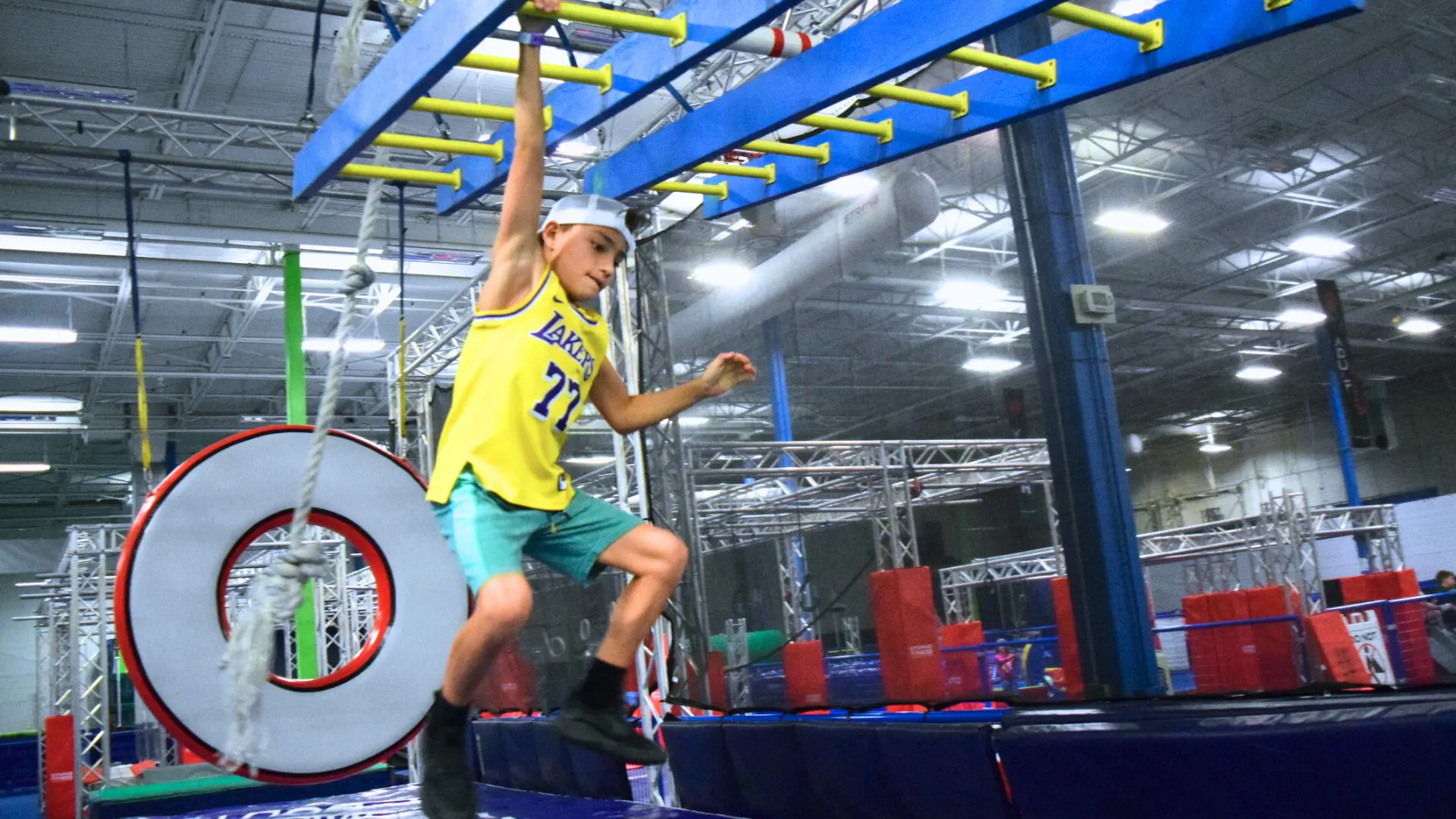 Kid jumping at the Active Play obstacle course at Strong